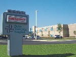 Outside Hospital Sign and Front view of the Hospital